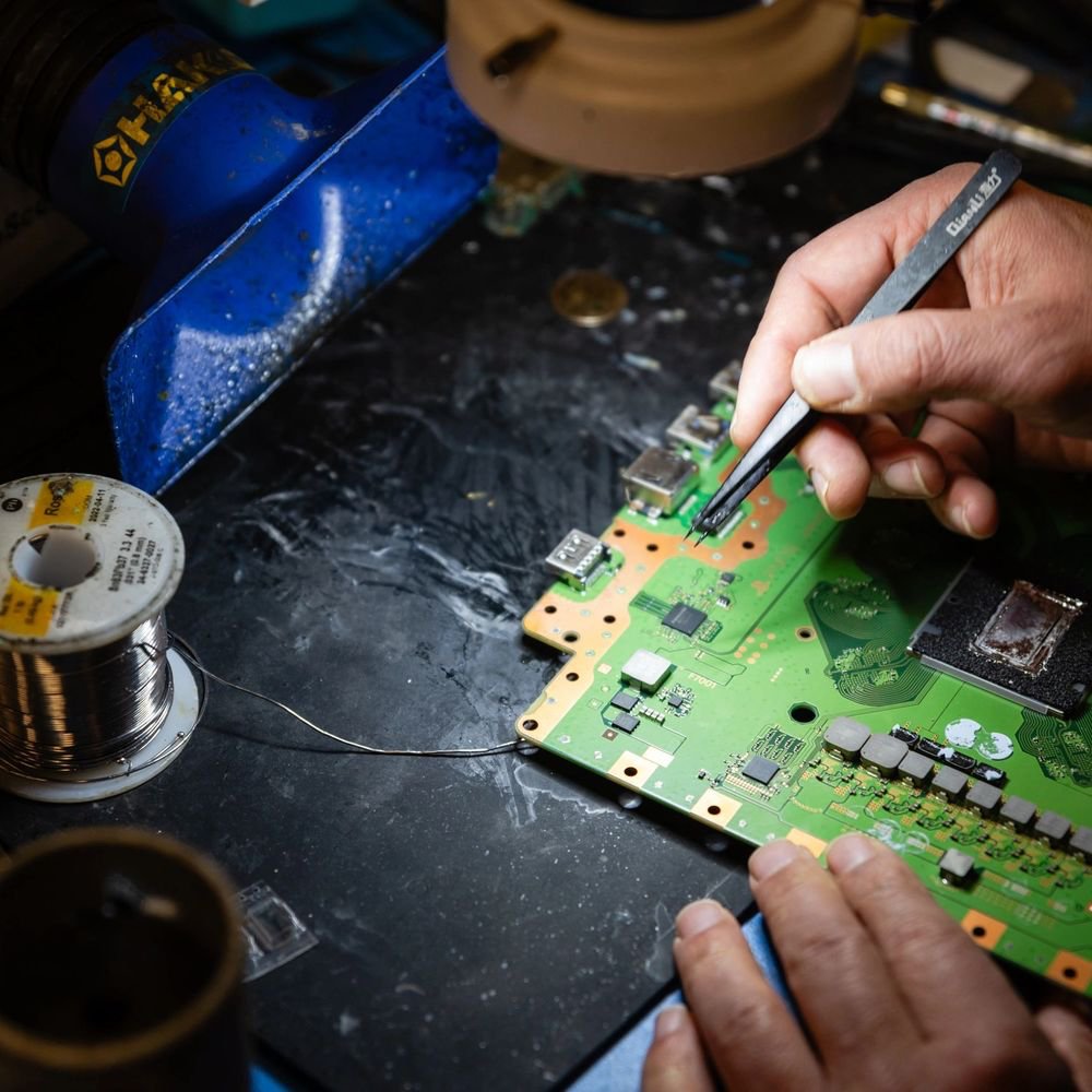 Technician performing component-level console board repair