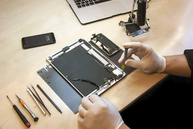 Technician performing tablet screen and internal repair